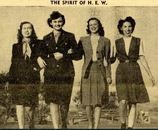 Historical black and white image of 4 women, 1 dressed in a military uniform. 