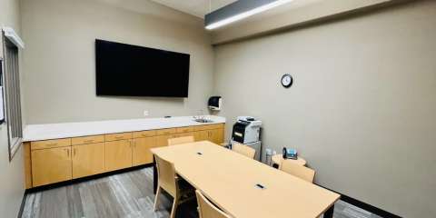 Conference Room with table and chairs, Smart TV on wall